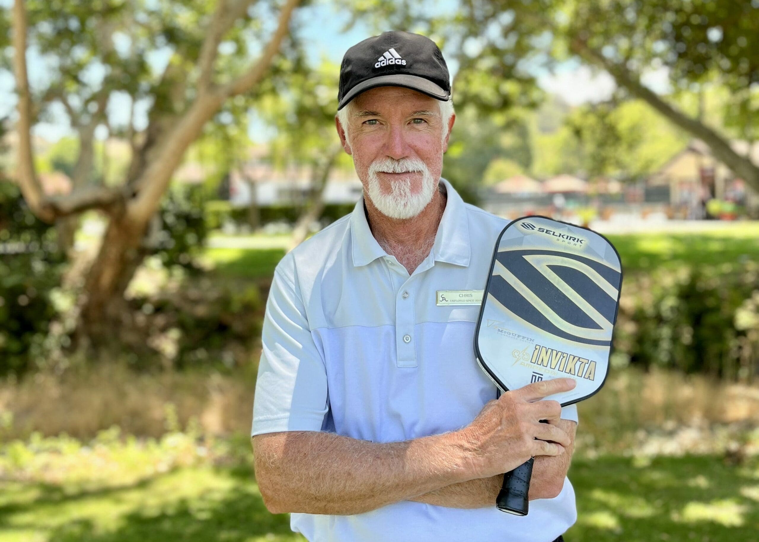 Head shot of Chris Devaux holding a pickleball paddle