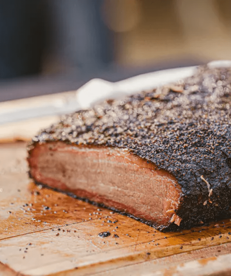 slab of meat on wooden cutting board