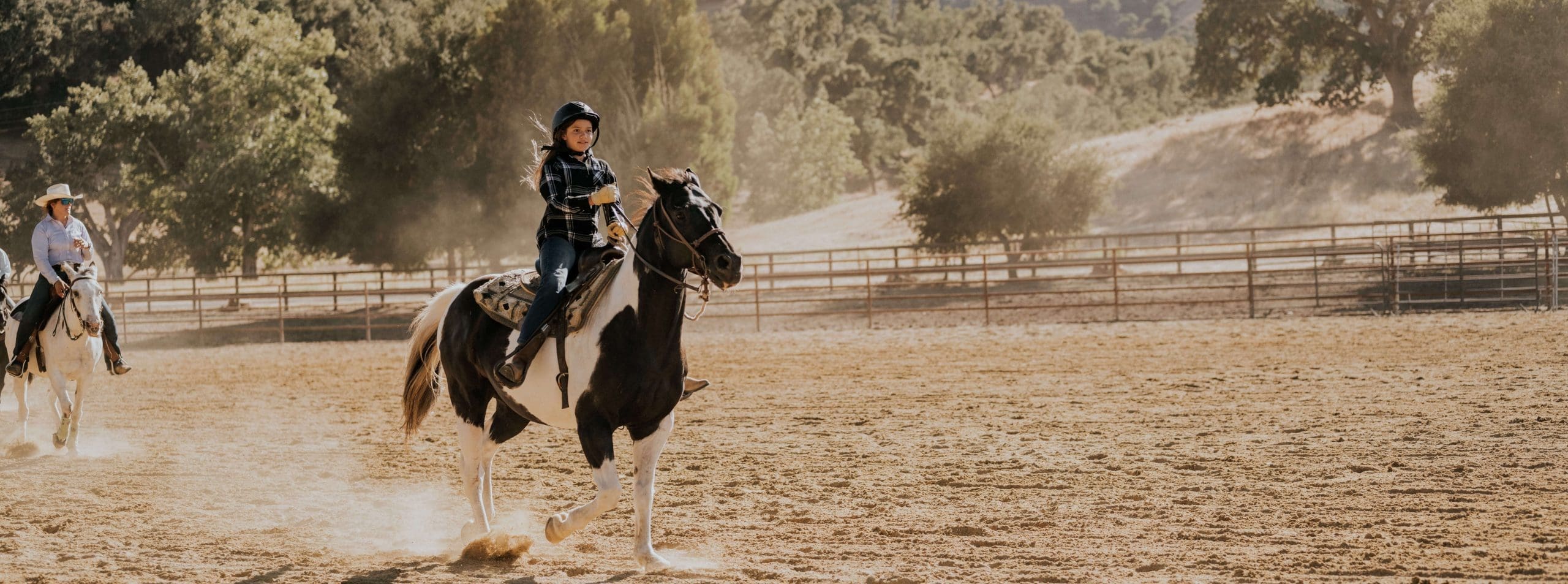 young person riding a horse