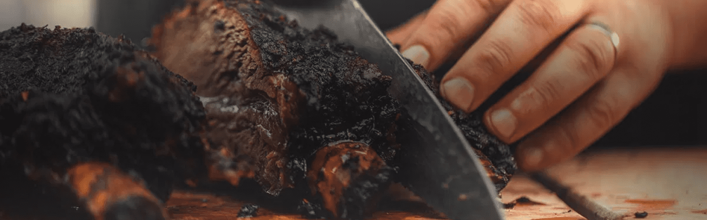 person cutting slices of meat