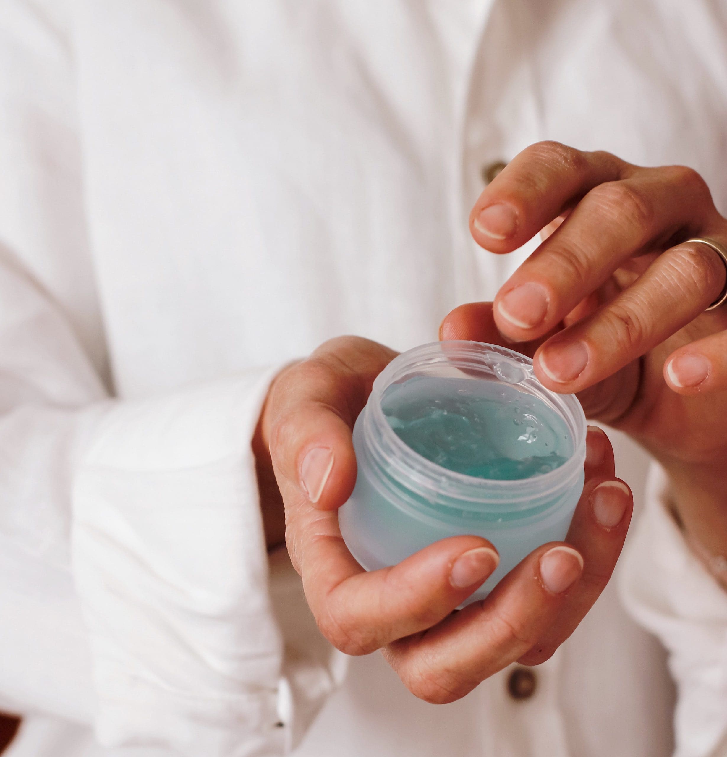 person holding container of gel product