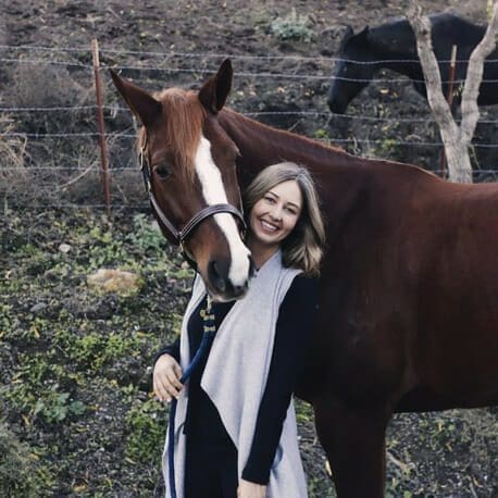 Danielle Pennewell beside a horse