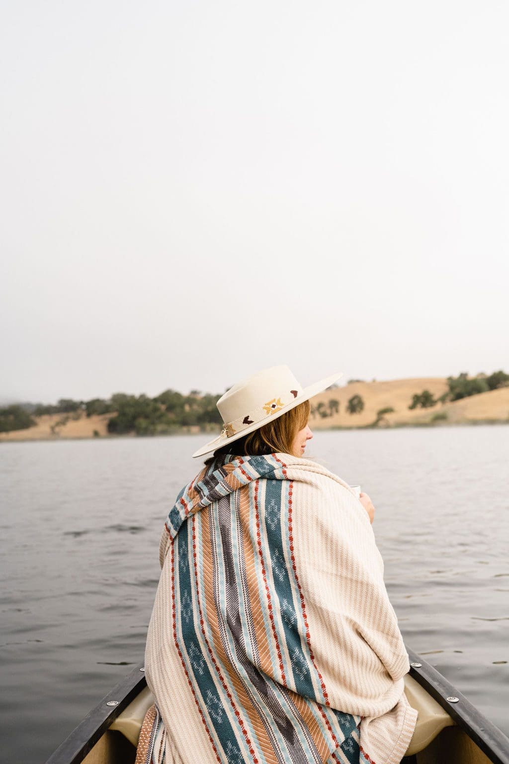 person under blanket on a small boat