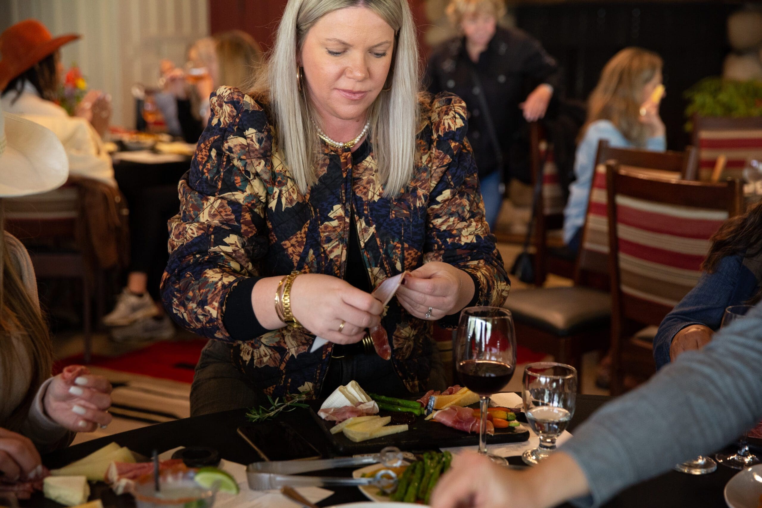 woman eating charcuterie board